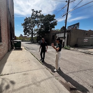 Davis, left, and Julia Hage from Center for Neighborhood Technology discuss future Bronzeville electric vehicle charging locations in the alley off 2400 block of Michigan Avenue.