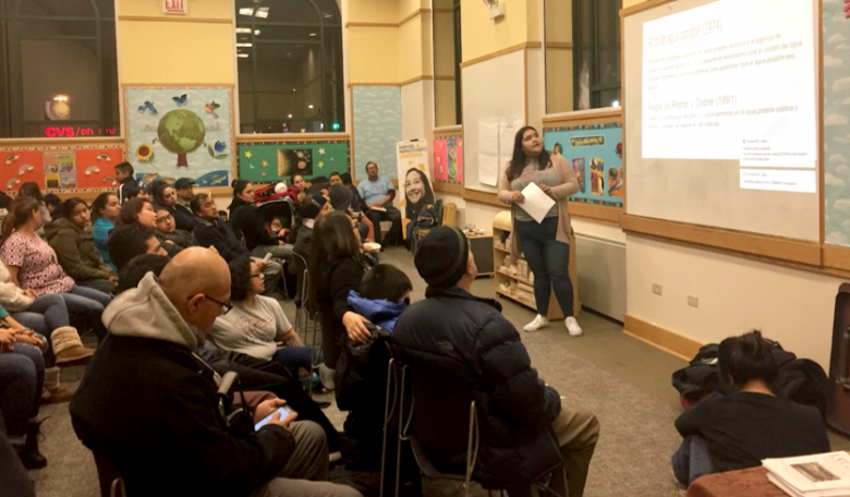 Senior Community Organizer Nancy Meza leads LVEJO's first community meeting at Zapata Elementary School in 2018 addressing water concerns in the Little Village Neighborhood. Photo by LVEJO Staff