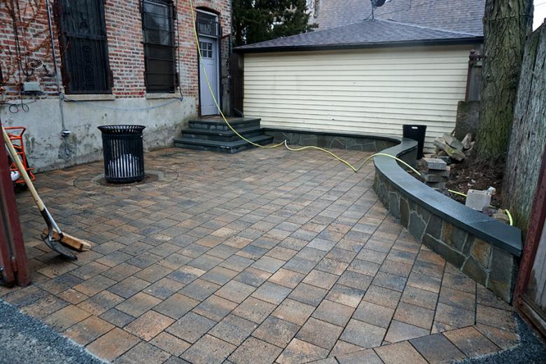 The completed patio, with new permeable pavers and raised garden beds, in which native prairie plants will be installed.