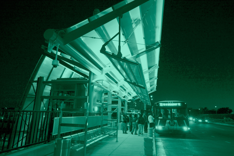 Passengers line up to enter a bus in Saint Louis