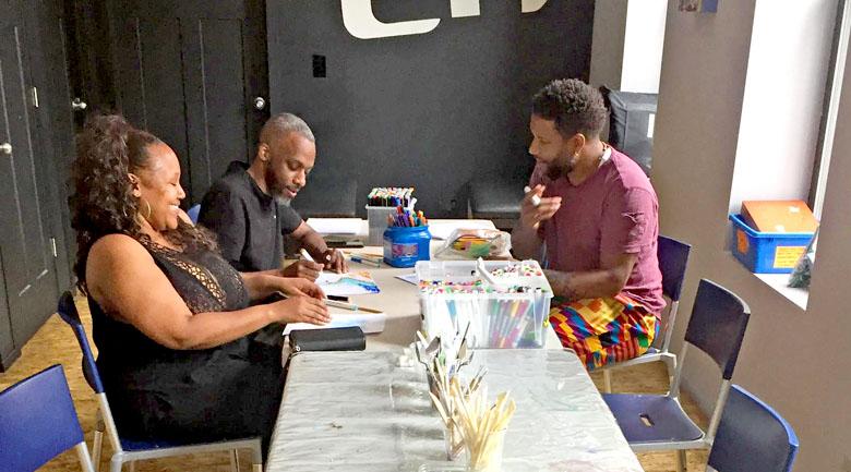 North Lawndale artist, Haman Cross III, prepares supplies for a design workshop.