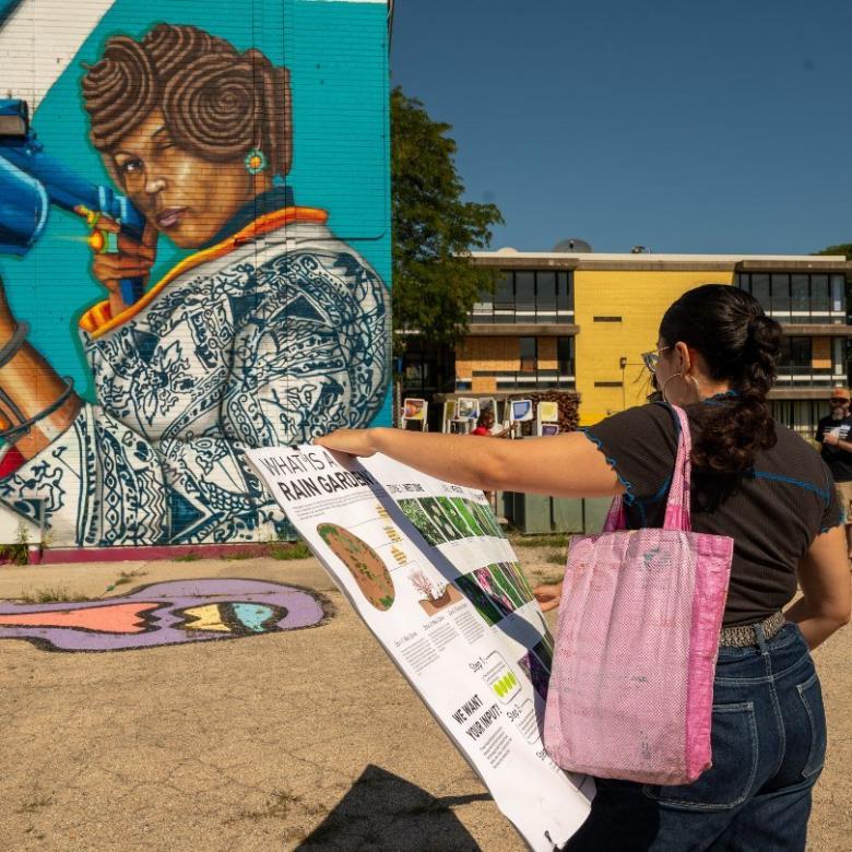 Overton school mural, Paulina Vaca with rain gardens poster. Photo by Tonal Simmons