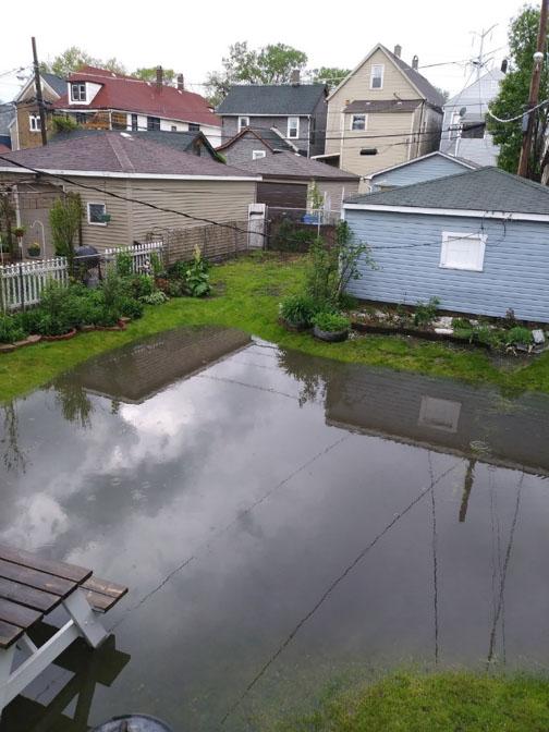 Backyards, like Ms. Vincent's, flooded for up to a week. Residents reported seeing a mix of gravel and sewage backing up into their basement plumbing.</br></br>Photo by Gloria Vincent Eastside Resident